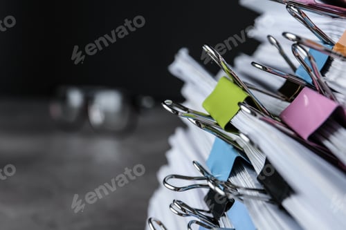 Preview: Stack of documents with binder clips on table, closeup view. Space for text