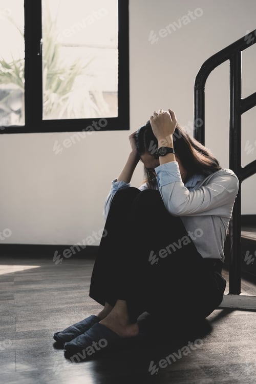 Preview: Frustrated woman sitting alone in home suffering from feeling lonely, upset, sad, unhappy.