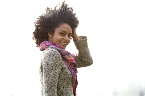 Preview: Attractive young african american woman with hand in hair