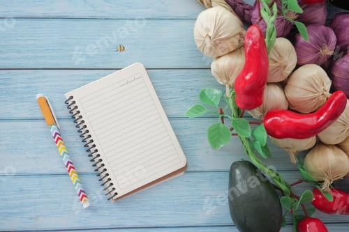Preview: Colorful vegetables and a notepad on a wooden table