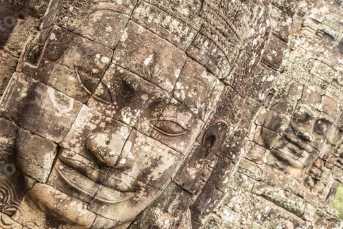 Preview: A beautiful face at the Bayan temple in Angkor Wat in black stone
