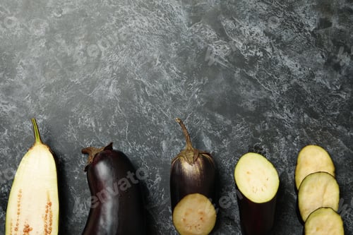 Preview: Fresh raw eggplants on black smokey background