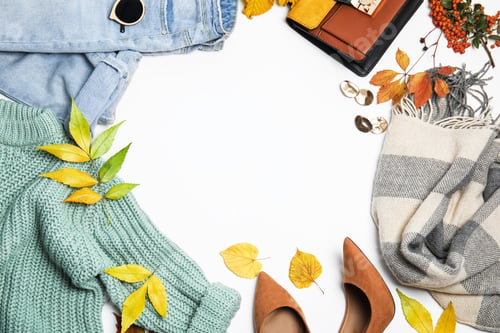 Preview: Warm clothes, autumn leaves and accessories on white background, top view. Space for text
