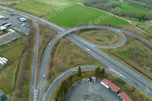 Preview: Aerial view of highway road intersection with fast moving heavy traffic.