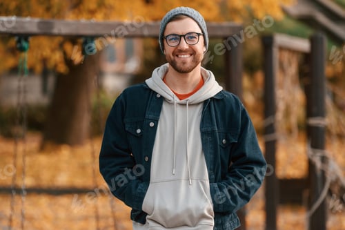 Preview: Beautiful man in warm clothes is outdoors in the park