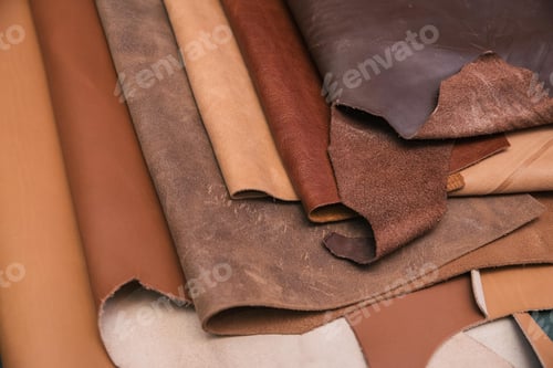 Preview: Array of leather fabric samples in different shades neatly placed on a table, ready to be crafted