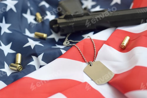 Preview: Army Dog tag token with 9mm bullets and pistol lie on folded United States flag