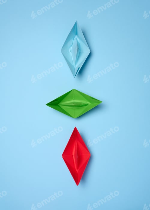 Preview: Three paper boats on a blue background, top view