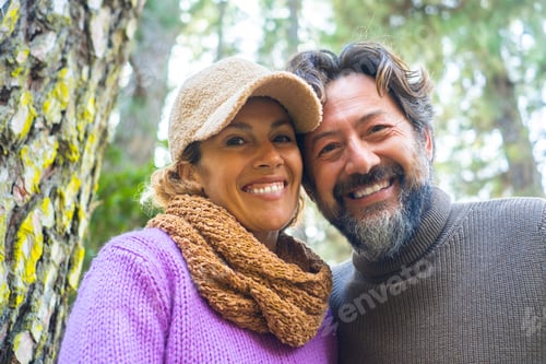 Preview: Cheerful and happy adult couple smile together at the camper in outdoor leisure activity