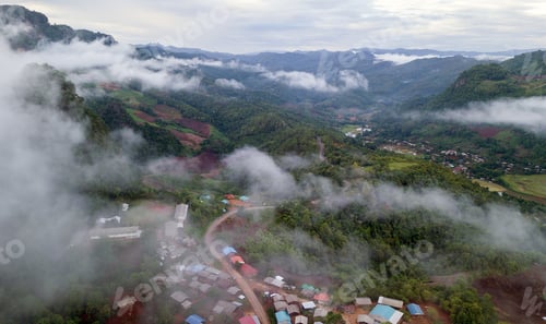 Preview: Top view of countryside road passing through the green forrest and mountain