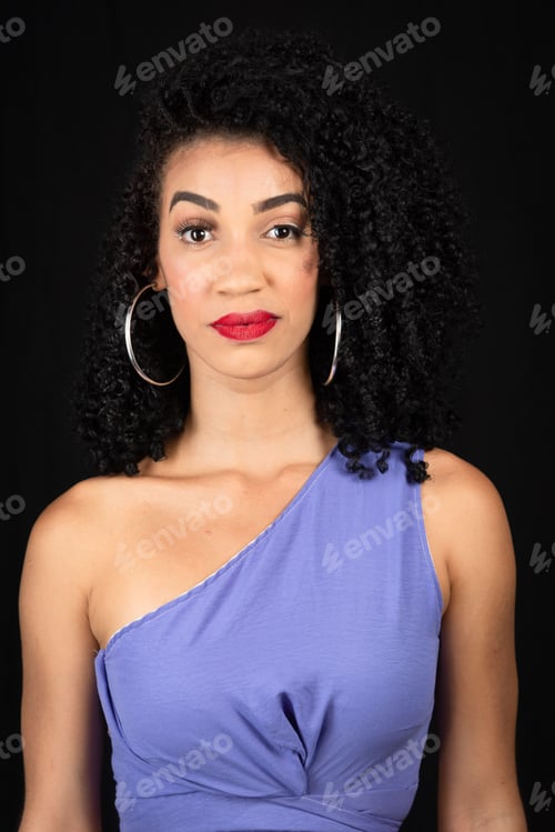 Preview: Portrait of serious, beautiful young woman wearing blue outfit.