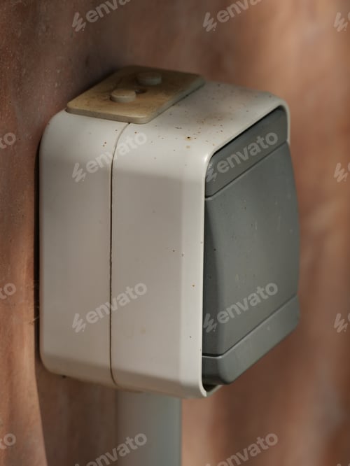 Preview: Vertical closeup shot of a small square electronic doorbell