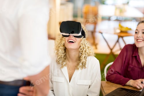 Preview: Blond woman trying out VR goggles at a workshop