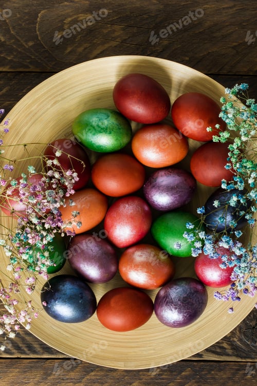 Preview: festive plate with Easter bright eggs and spring flowers. top view.