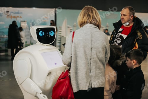 Preview: Futuristic robot talking to people at an exhibition of modern technologies. Education, future. N