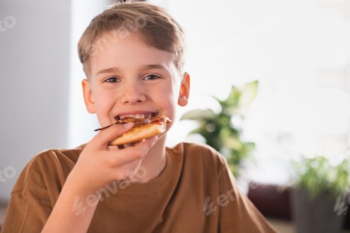 Preview: Happy teenager enjoying eating delicious pizza at home.
Freshly baked pepperoni pizza