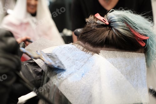 Preview: A hairdresser at the beauty salon with clients