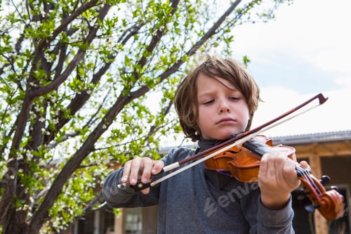 Preview: 6 year old boy playing violin outside of his home