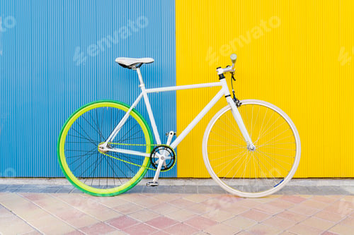 Preview: City bicycle fixed gear on blue and yellow wall.