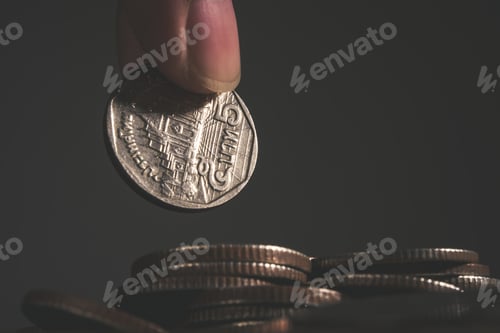 Preview: Woman hand puts a coin in stacked.