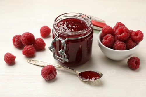 Preview: Tasty jam and fresh ripe raspberries on white wooden table, closeup