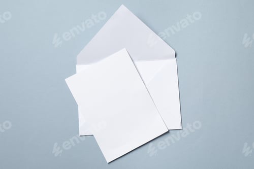 Preview: Letter envelope and card on grey background, top view. Space for text