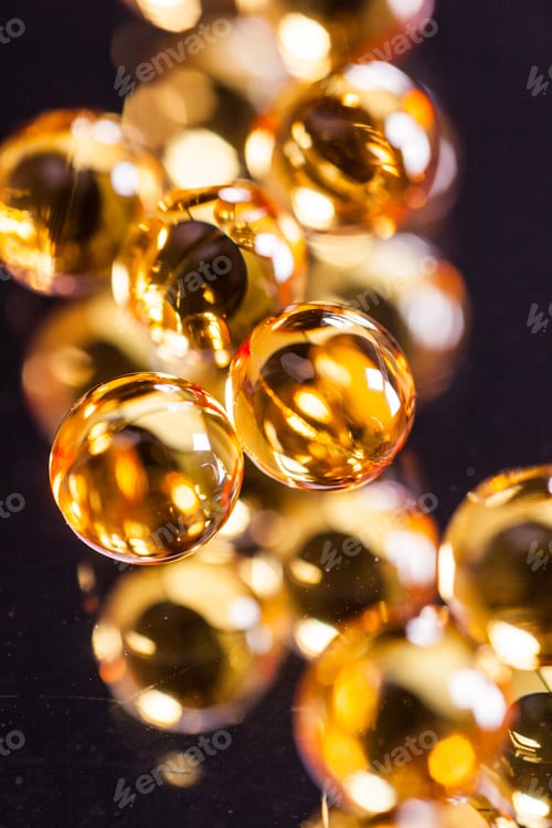 Preview: orange capsules on mirror background