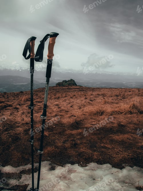 Preview: Vertical shot of trekking poles on a mountain