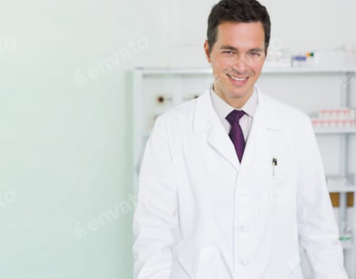 Preview: Male physician standing at clinic by shelving with meds, lab coat, pen visible, copy space