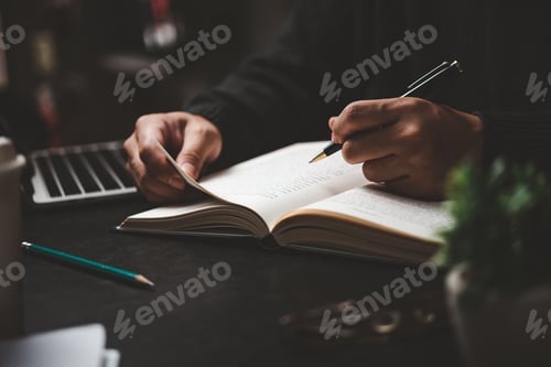 Preview: Businessperson reading and writing on book.education studying knowledge development