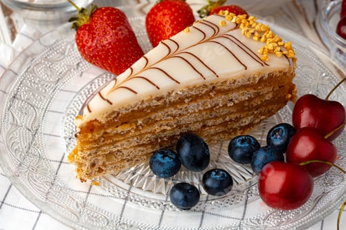 Preview: Piece of esterhazi cake decorated with fresh berries