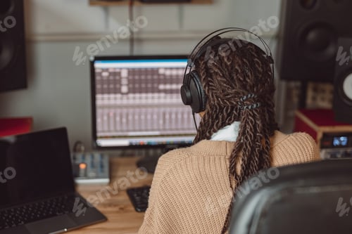 Preview: Sound engineer using control desk recording new track for album in soundproof room of music studio
