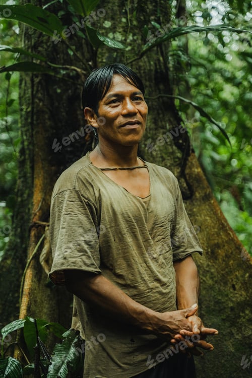 Preview: Ethnic man standing in forest