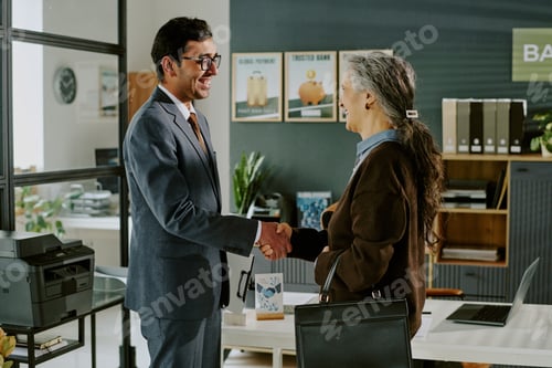 Preview: Handshaking Between Business Colleagues in Office Setting