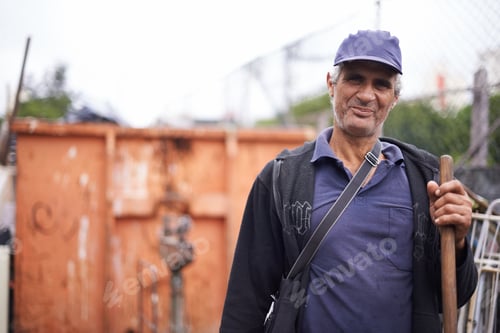 Preview: Work is hard to come by. A cropped portrait of a street sweeper standing with his broom.
