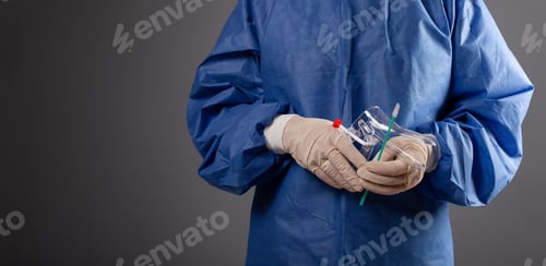 Preview: Gloved Professional Holds Instruments in Health Setting