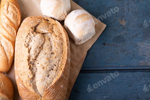 Preview: Close-up of various breads on brown wax paper at table