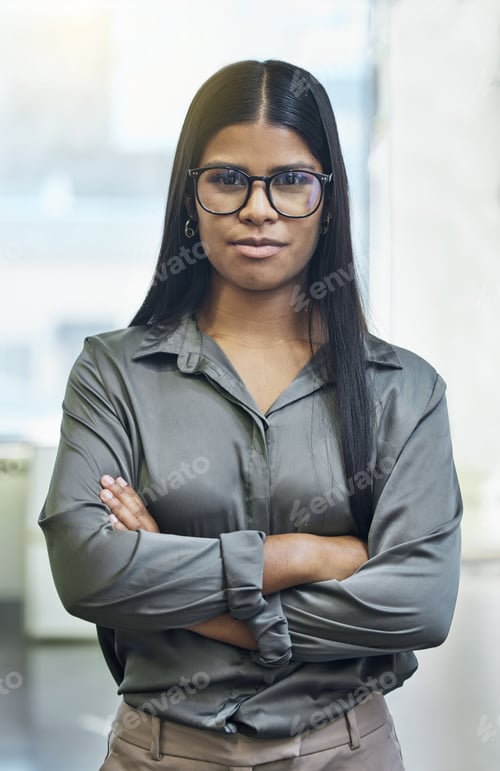 Preview: Cropped portrait of an attractive young businesswoman standing with her arms folded in the office