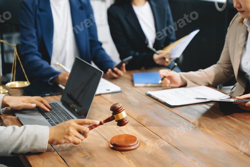 Preview: business people and lawyers discussing contract papers sitting at the table.