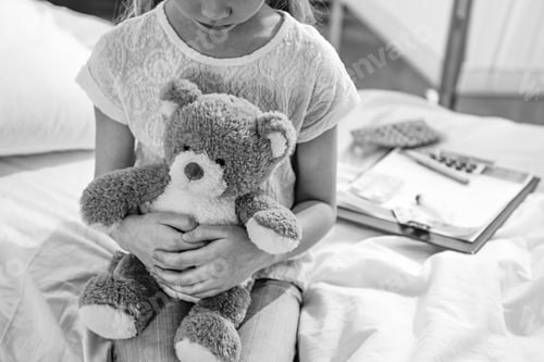 Preview: partial view of girl with teddy bear in hospital chamber, black and white photo