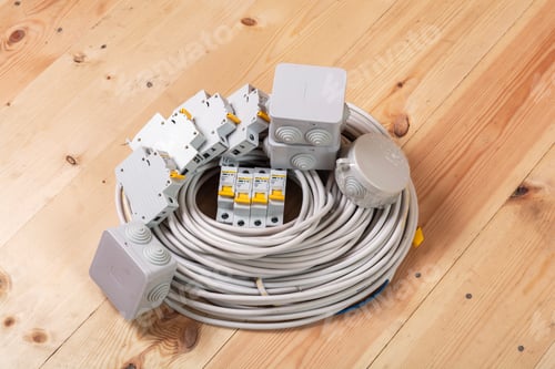 Preview: Electrical cables and circuit breakers arranged on wooden surface for installation