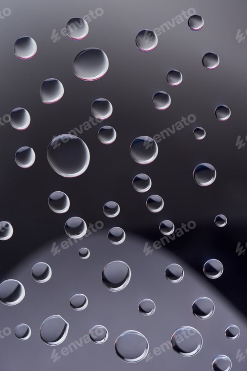 Preview: close-up view of transparent water drops on dark background
