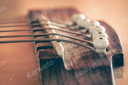 Preview: Acoustic guitar bridge and strings close up.