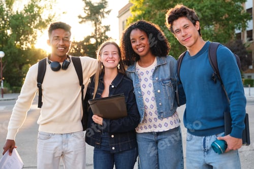 Preview: Diverse group of college students smiling on campus walking
