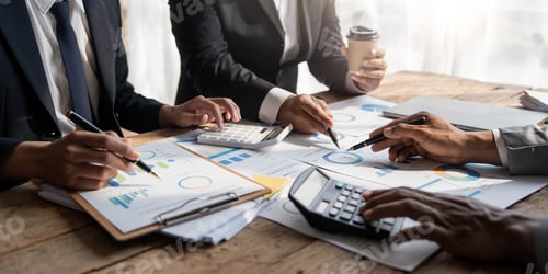 Preview: Business People Meeting using laptop computer,calculator,notebook,stock market chart paper for