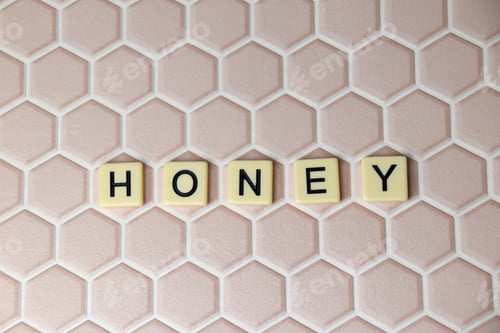 Preview: the word honey spelled out in letter tiles on pink tiled background