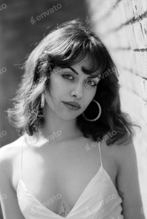 Preview: Romantic black and white portrait of sensual woman posing outside.
