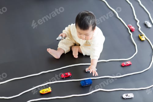 Preview: Cute baby playing with toy cars
