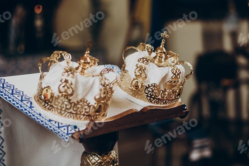 Preview: Golden christianity crowns on altar in church for wedding ceremony