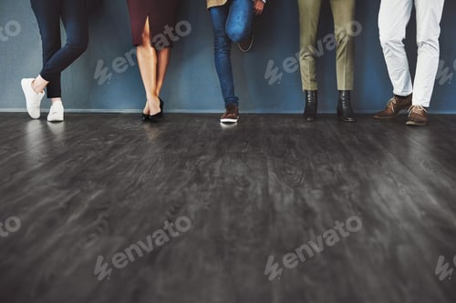Preview: Stylish People Standing Against a Gray Wall